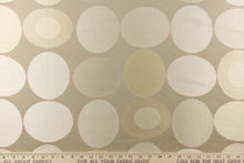 Load image into Gallery viewer, Stylish, modern and contemporary best describe this geometric pattern of circles and ovals in champagne or cream and light gold on a beige background. 
