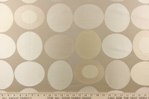 Stylish, modern and contemporary best describe this geometric pattern of circles and ovals in champagne or cream and light gold on a beige background. 