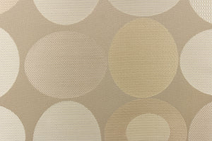 Stylish, modern and contemporary best describe this geometric pattern of circles and ovals in champagne or cream and light gold on a beige background. 