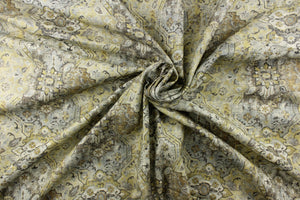 This medium weight fabric features a unique abstract design in muted golds, gray, yellow, off white and charcoal.