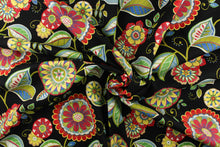 Load image into Gallery viewer, This bright fabric features a funky floral design in vivid colors of red, blue, green, yellow, white, and dark pink against a black background.
