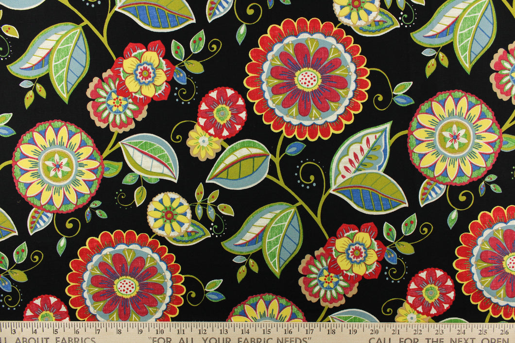 This bright fabric features a funky floral design in vivid colors of red, blue, green, yellow, white, and dark pink against a black background.