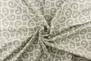 This fabric feature a delightful design of swirled lines that touch sides in white on a light gray background.