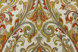  A gorgeous pattern featuring a framed design with a paisley look in brunt orange, yellow orange, gray, olive green on a beige background. 