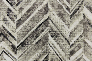 This fabric features a chevron design in shades of black, gray and white
