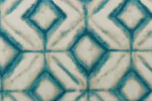 This fabric features a geometric design of diamonds in turquoise with white and hints of gray.