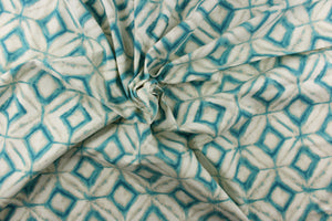This fabric features a geometric design of diamonds in turquoise with white and hints of gray.