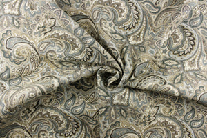 This fabric features a paisley design in blue tones, gray, white, brown, and khaki tones. 