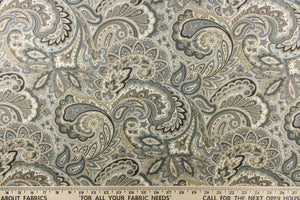 This fabric features a paisley design in blue tones, gray, white, brown, and khaki tones. 