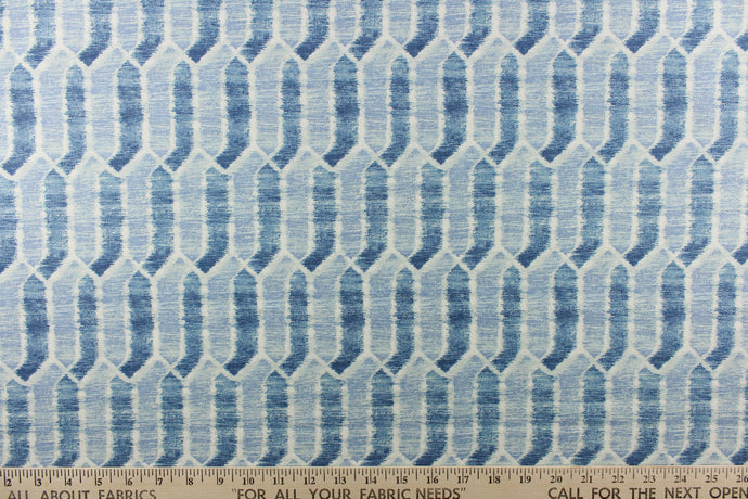  This fabric features a geometric design in shades of blue and white. 