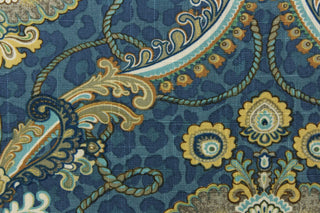 This unique fabric feature a medallion in gold tones, gray, cream and blue against a blue cheetah print.