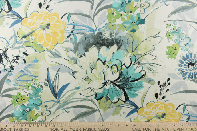 This fabric feature a large floral pattern in colors of yellow, blues, green, turquoise, and black set against a white background. 
