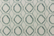 Load image into Gallery viewer, This fabric features a geometric design in a gray green and blue against a white background. 
