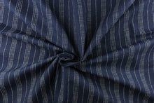 Load image into Gallery viewer, This fabric features a multiply white dot stripes against a blue background.
