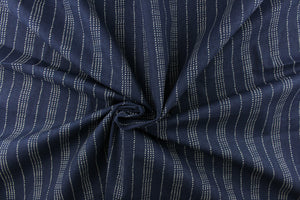 This fabric features a multiply white dot stripes against a blue background.
