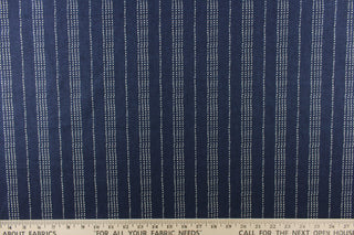 This fabric features a multiply white dot stripes against a blue background.