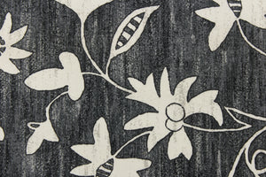 This simple, pretty floral design has white floral with hints of gray on a black background.