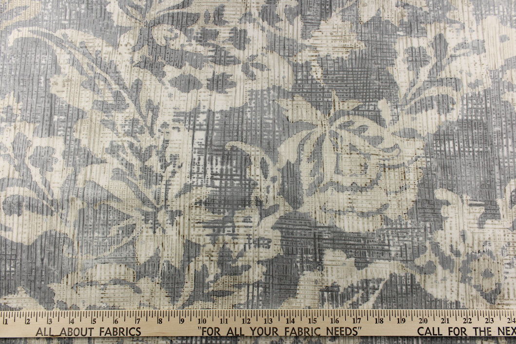 A unique pattern featuring a floral design that is visible from a distance and blurs or blends as you get closer in cream, light and dark gray with some hits of dark brown or beige. I