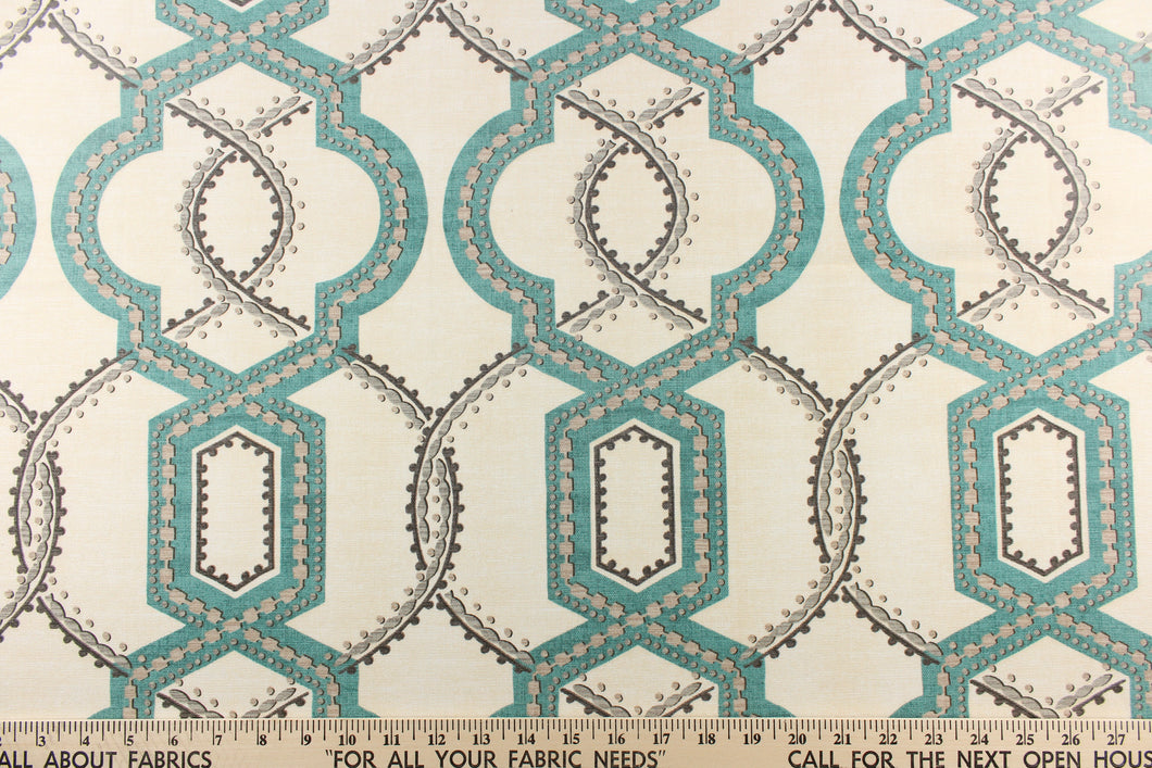 This contemporary design feature a geometric, quatrefoil pattern with gray, turquoise blue, and khaki colors on a natural background. 