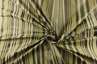 This stunning yarn dyed fabric features a multi width striped pattern in colors of dark green, silver, and khaki or beige.