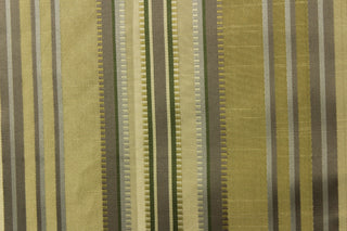 This stunning yarn dyed fabric features a multi width striped pattern in colors of dark green, silver, and khaki or beige.