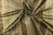 Load image into Gallery viewer,  This stunning yarn dyed fabric features a multi width striped pattern in colors of green, rust, gold and pewter 
