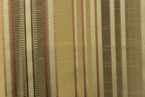  This stunning yarn dyed fabric features a multi width striped pattern in colors of green, rust, gold and pewter 