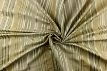 Load image into Gallery viewer, This stunning yarn dyed fabric features a multi width striped pattern in colors of green, silver, and gold 
