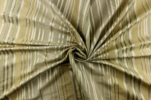 This stunning yarn dyed fabric features a multi width striped pattern in colors of green, silver, and gold 