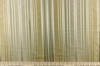 This stunning yarn dyed fabric features a multi width striped pattern in colors of green, silver, and gold 