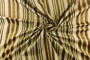 This stunning yarn dyed fabric features a multi width striped pattern in colors of green, mauve, gold and brown. 