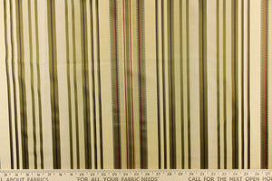 This stunning yarn dyed fabric features a multi width striped pattern in colors of green, mauve, gold and brown. 
