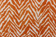 Load image into Gallery viewer,  This fabric features a chevron tiger stripe in orange against a white background. 
