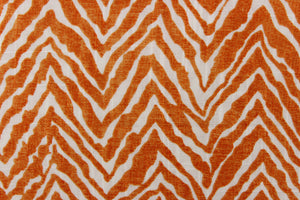  This fabric features a chevron tiger stripe in orange against a white background. 