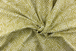 This fabric features a chevron tiger stripe in lime green  against a white background. 