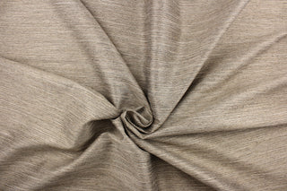 This multi-purpose mock linen features a striae pattern in sand dune  with black undertones.  This classic raw silk look is suitable for draperies, curtains, cornice boards and headboards.  We offer this fabric in other colors.