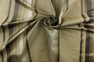 Rich and formal describe this medium weight yarn dye fabric which features a multi width striped pattern in colors of gold, gray and khaki or beige .