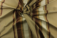 Load image into Gallery viewer, Rich and formal describe this medium weight yarn dye fabric which  features a multi width striped pattern in gold, brown tones, champagne. 
