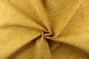 This bright fabric features a geometric design of white triangles against a canary yellow background. 
