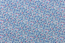 Load image into Gallery viewer, This fabric features a dainty floral design in pale blue  with pink , blue and white flowers . 
