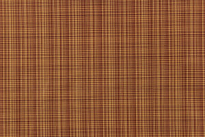 This stunning yarn dyed fabric features a small plaid design in a deep red and golden tan. 