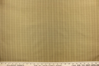 This stunning yarn dyed fabric features a small plaid design in beige and brown tones .
