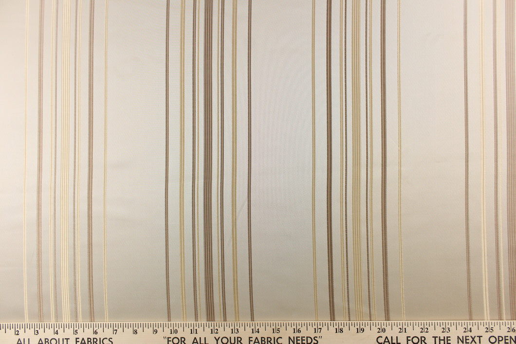This rich woven yarn dyed fabric features narrow width light and dark khaki stripes on a cream background.
