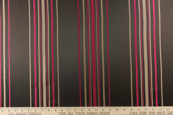 This rich woven yarn dyed fabric features narrow width dark pink and brown tone stripes on a dark brown ground. 