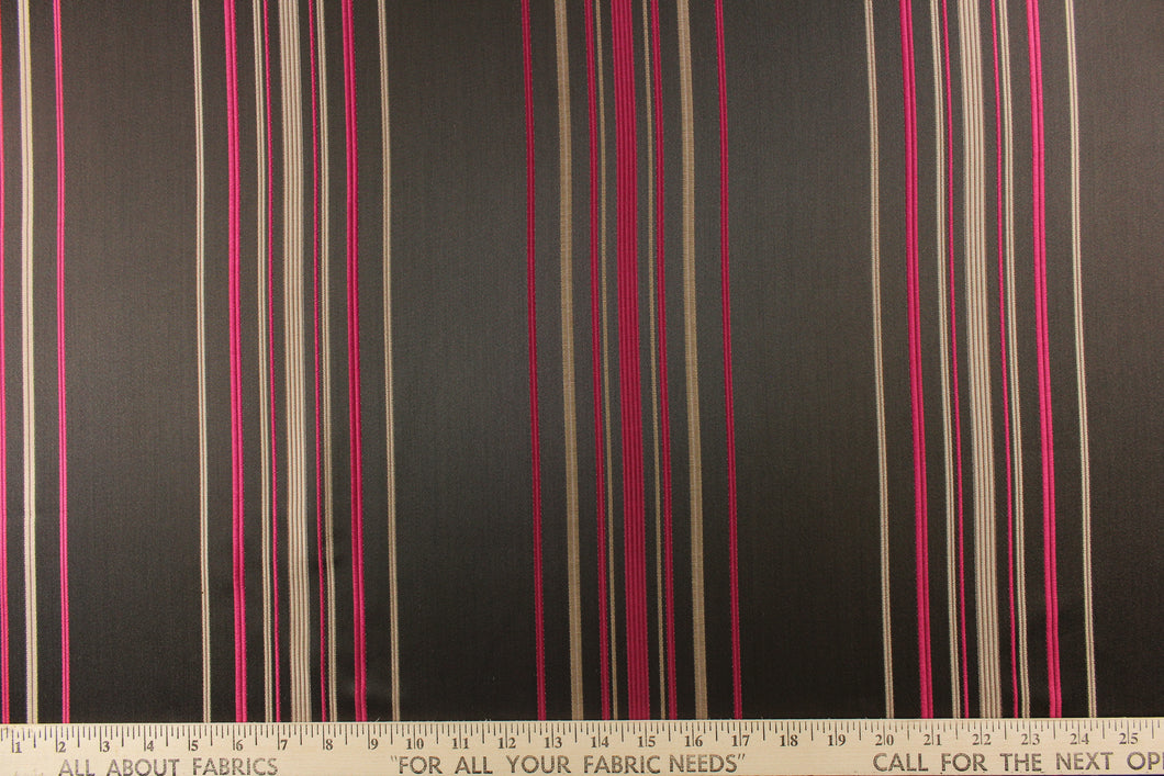 This rich woven yarn dyed fabric features narrow width dark pink and brown tone stripes on a dark brown ground. 